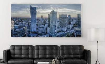 Obraz na płótnie Panorama miasta Warszawa z nowoczesnym wieżowcem o zachodzie słońca