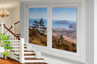 Fototapeta okno z widokiem górskiego krajobrazu na tle morza