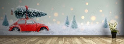 Fototapeta Czerwony samochód wiozący choinkę w śnieżnym lesie