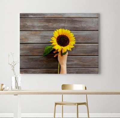 Obraz na płótnie Bukiet słoneczników na ciemnym drewnianym tle z desek