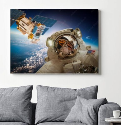 Obrazy do salonu Astronauta na tle ziemi