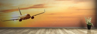 Fototapeta Samolot na niebie o wschodzie słońca
