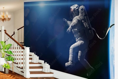 Fototapeta astronauta wykonujący spacer kosmiczny po orbicie planety Ziemia