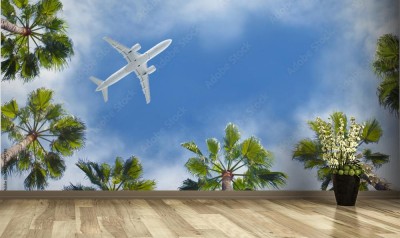 Fototapeta Samolot pasażerski lecący nad tropikalnymi palmami