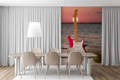 Fototapeta Gitara plaża i morze o zachodzie słońca