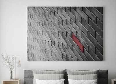 Obraz na płótnie Czarno-biały mur z jedną czerwoną cegłą