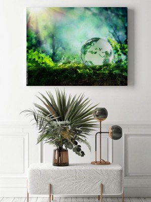 Obraz na płótnie Zielony biznes - kula ziemska na mchu w lesie