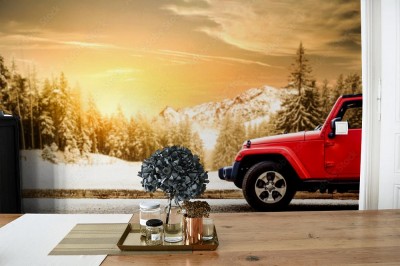 Fototapeta Czerwony Jeep w zimowym krajobrazie gór