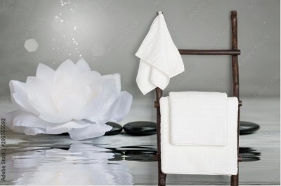 Fototapeta Spa - martwa natura z lilią wodną i kamieniami do masażu