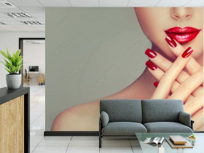 Fototapeta Piękna dziewczyna pokazuje czerwonych manicure gwoździe  makijaż i kosmetyki