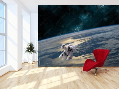 Fototapeta Astronauta unosi się nad Ziemią