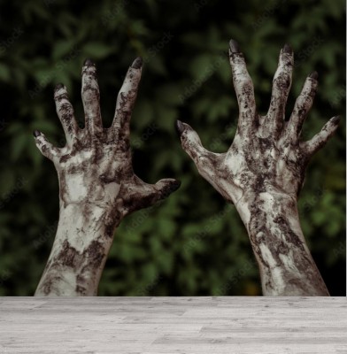 Fototapeta Straszne ręce zombie zabrudzone czarnymi gwoździami sięgają po zielone liście