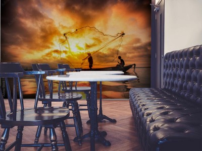 Fototapeta Rybak podczas połowów przy wschodzącym słońcu