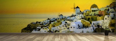 Fototapeta Wyspa Santorini mieniąca się żółtym światłem zachodzącego słońca 