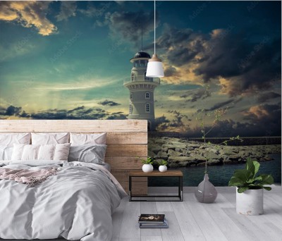 Fototapeta Biała latarnia morska pod chmurami