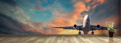 Fototapeta Lądujący samolot na tle kolorowych chmur