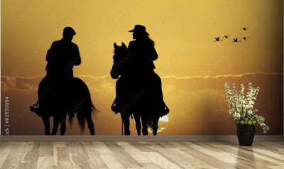 Fototapeta Kowboj na tle zachodzącego słońca