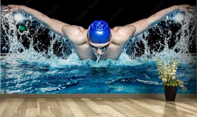 Fototapeta Mięśni młody człowiek w niebieskiej czapce w basenie