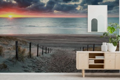 Fototapeta Ścieżka piasku do plaży Morza Północnego o zachodzie słońca